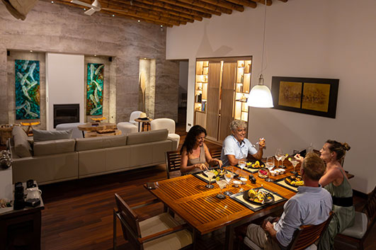 Reyna and Roberto having dinner with guests in one of the Galapagos  Villas - Sustainability comes first