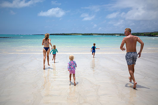 Montemar's Guest family playing and enjoying the beach, sea and island on the background