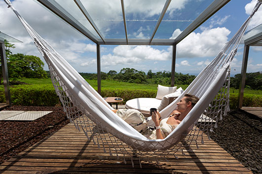 Guest relaxing in a hammock on Montemar Eco Villa