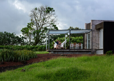 Villa Lechuza, view of the outside deck, garden, green field and trees in the background