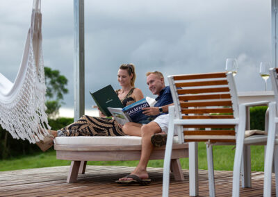 Guests relaxing and reading on the deck of Lechuza Villa