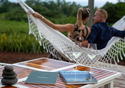 A couple of guests in Villa Lechuza, enjoying the hammock and wine