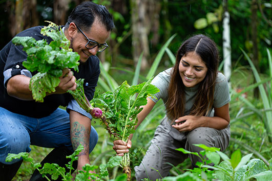 Guest and a member of Montemar Sustainable Villas team harvesting the food direct from the main garden