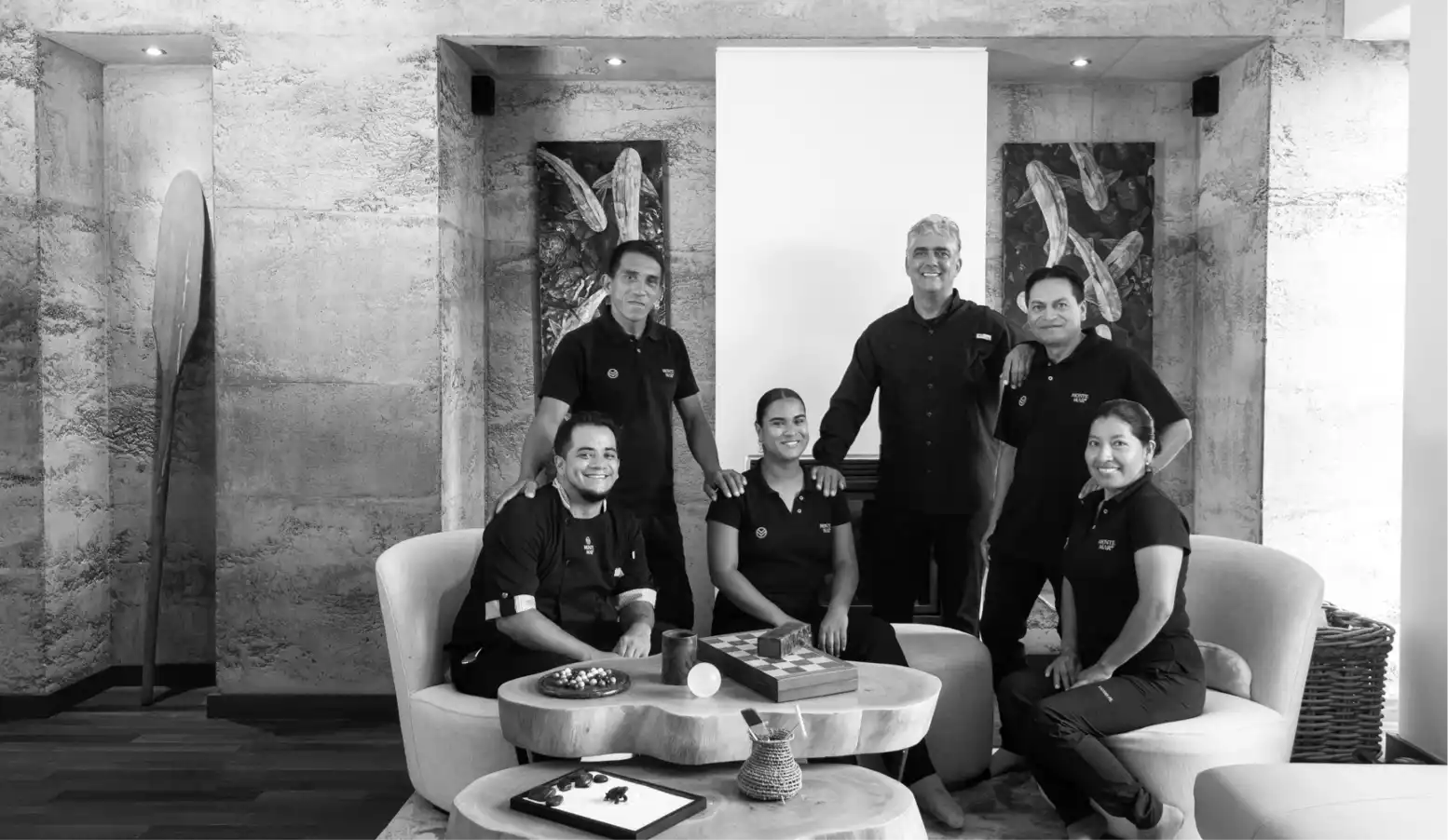 Group of people posing inside a hotel or corporate lobby.