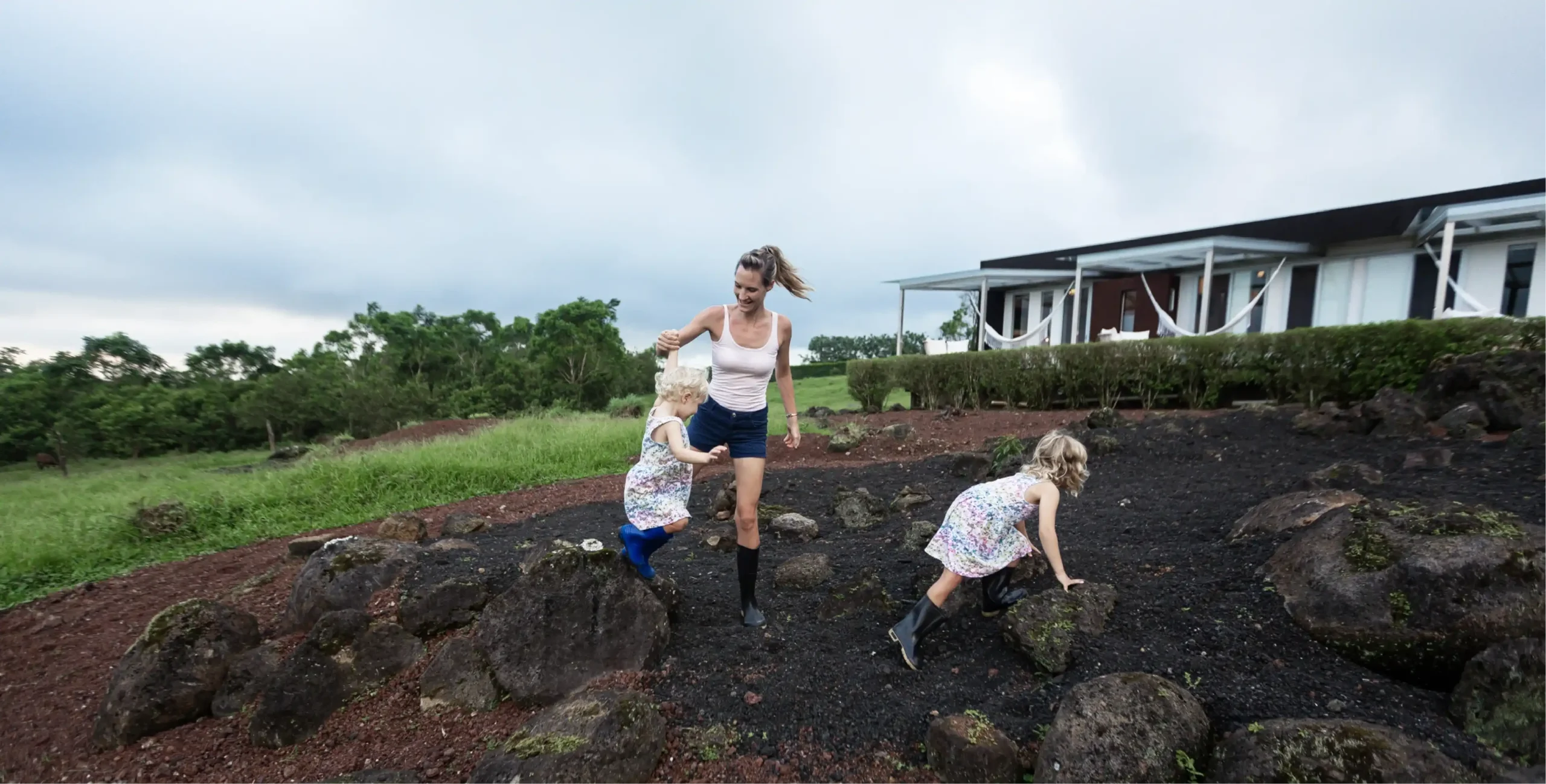 Woman and child farming on rural land.