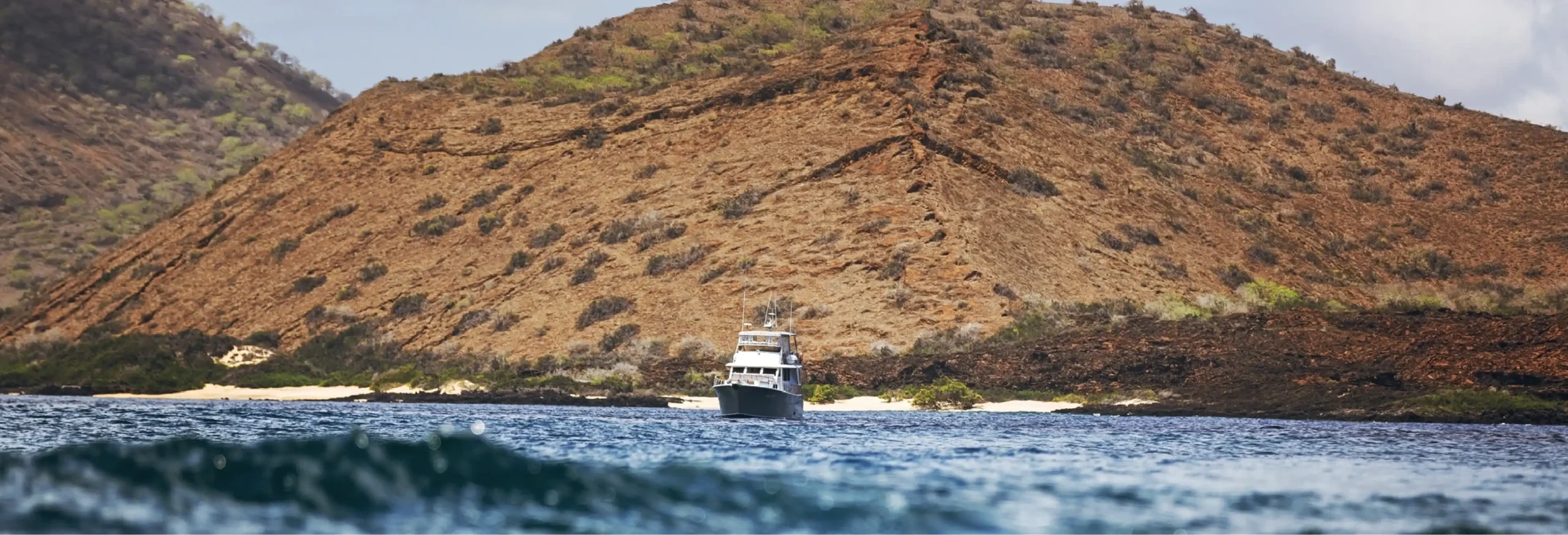 Boat near rocky island coast.