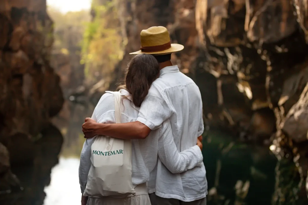 Couple walking through a Galápagos canyon at Montemar