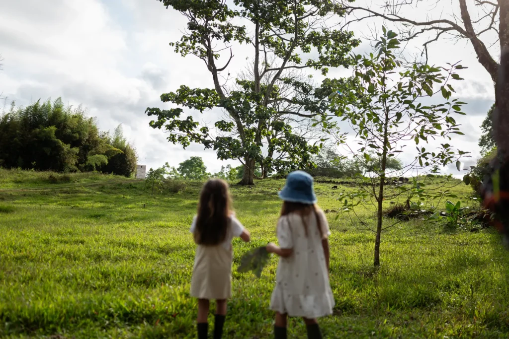 Two girls exploring the farmland at Montemar Galápagos